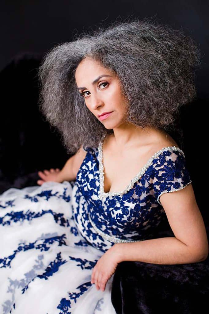 iranian-woman-with-curly-hair-in-blue-white-evening-gown-studio-portrait-by-photographer-in-london