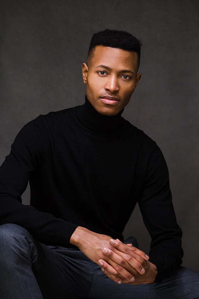 african-black-man-in-short-cropped-hair-black-polo-neck-jumper-