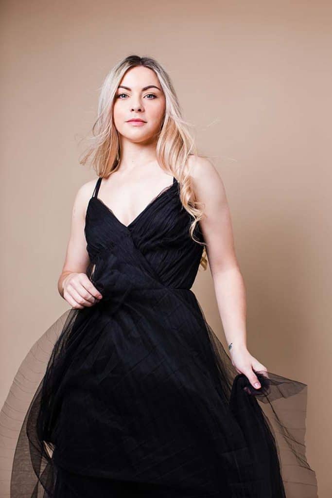blonde-girl-with-curly-hair-holding-black-tulle-dress-glamour-look-crouch-end-photographer