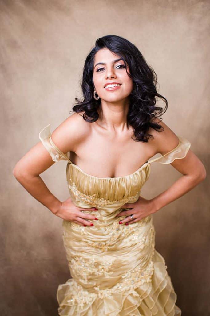 middle-eastern-iranian-girl-in-black-curly-hair-gold-dress-posed-for-photo-mayfair-london-portrait