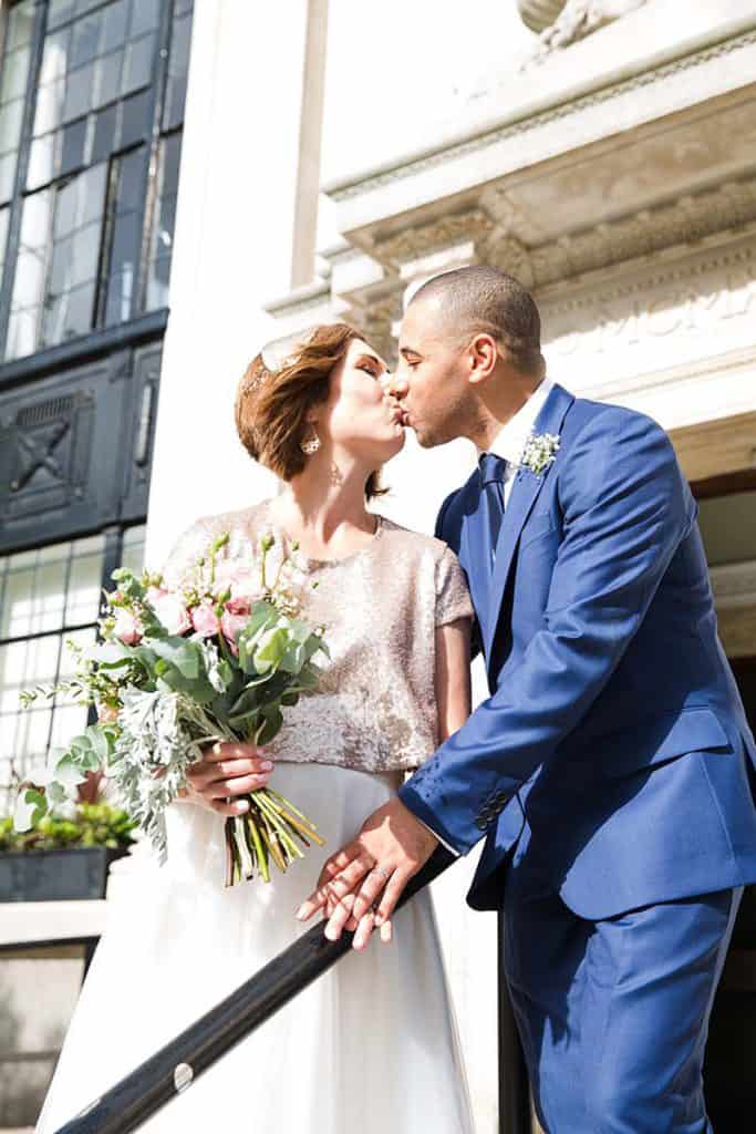 wedded-couples-kissing-on-the-steps-outside-islington-town-hall