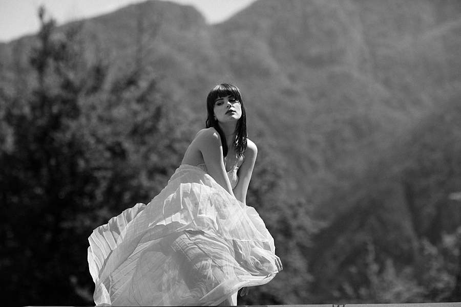 portrait-photography-girl-with-flying-dress-in-front-of-mountains
