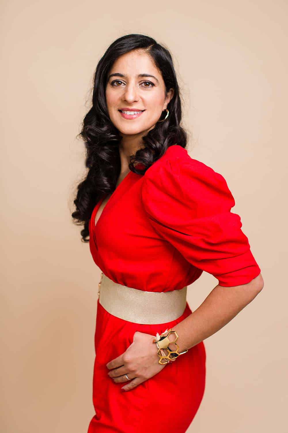 Branding-photography-of-asian-woman-speaker-in-red-jumpsuit-turning-sideway-while-looking-at-camera