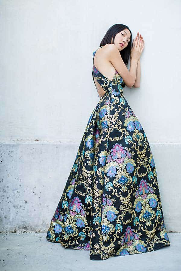 Fashion portrait of a woman in patterned gown posing in editorial style