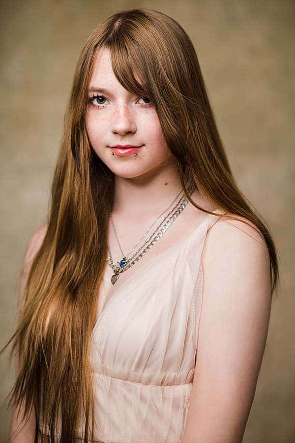 Teenage daughter photoshoot London studio wearing elegant gown from studio wardrobe