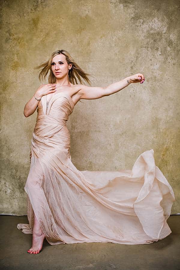 Glamorous mother photoshoot in London studio wearing flowing evening gown