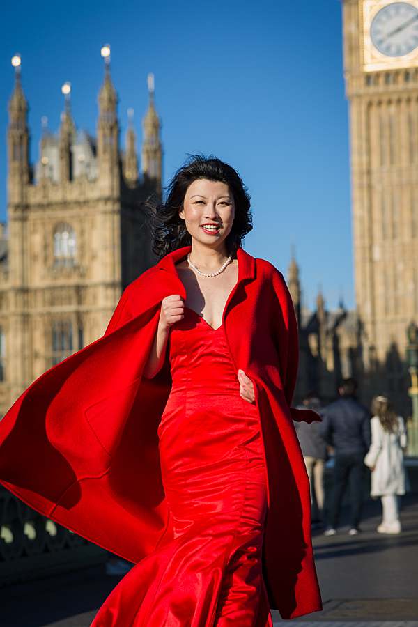 Woman in red evening gown posing near Big Ben during luxury 50th birthday photoshoot in London by Belinda Burton Photography