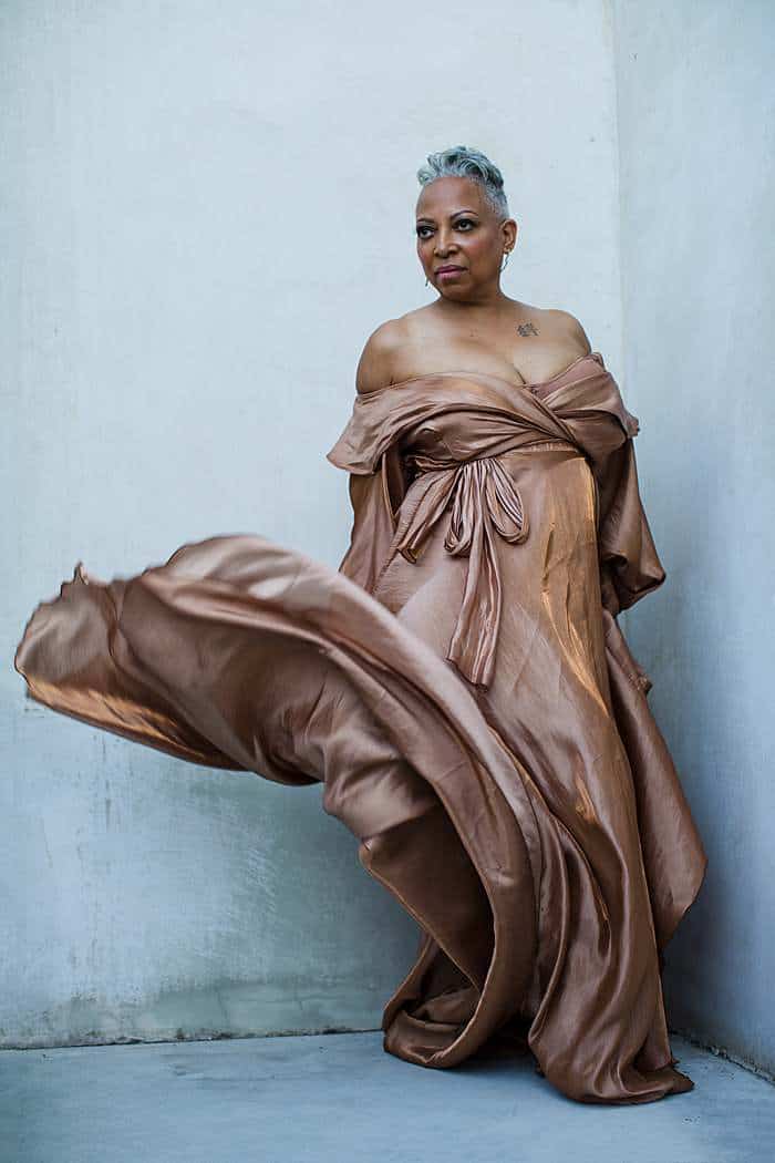 Elegant women’s portrait in London with flowing dress and confident pose